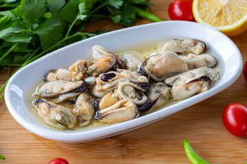 Close-up marinated mussels on wooden background. Seafood dishes. local name marineli midye
