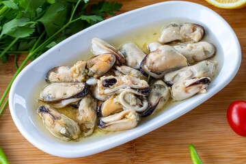 Close-up marinated mussels on wooden background. Seafood dishes. local name marineli midye