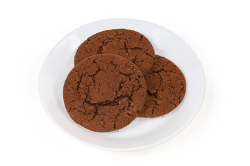 Round chocolate cookies on dish on a white background