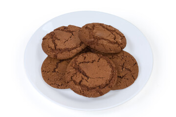 Round chocolate cookies on big dish on a white background