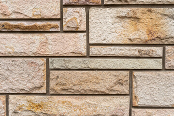 Close-up of wall built with decorative rectangular stones.