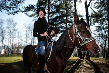 Beautiful Woman Rides a Horse Wearing a Helmet