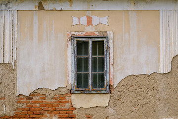 Old window in damaged wall