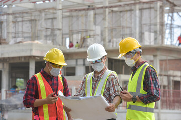 Construction engineers supervising progress of construction project