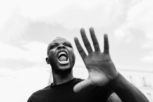Aggressive black protester shouting on city street