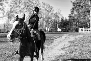 Fototapeta na wymiar Young Woman Riding a Horse
