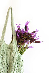 Detail of cotton crochet bag with lavender flowers, reusable concept