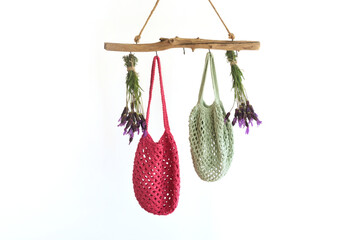 Hanger with cotton bags and fresh flowers, decoration