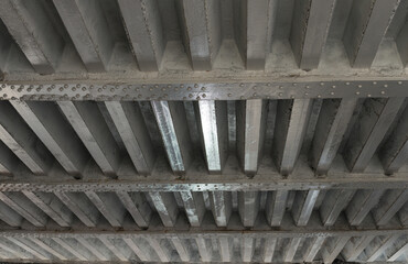 detail of iron girders or support beams beneath a bridge