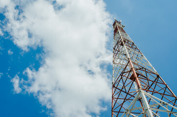 metal tower for mobile radio communication on a background of blue sky