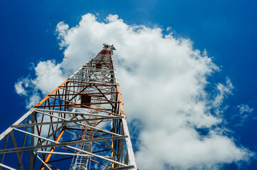 metal tower for mobile radio communication on a background of blue sky