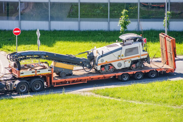 Transportation of equipment for cutting and removing old asphalt pavement for road repair on a...
