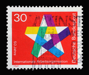 Stamp printed in Germany showing a five-pointed colorful star, 50 years of the International Labor...