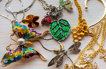 a lot of costume jewelry with different materials on a black background