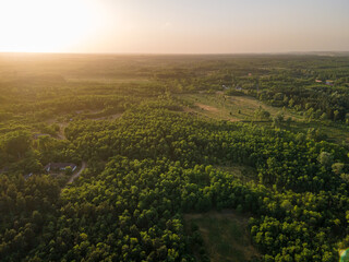 View of sunset above forest and fields