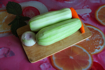 Zucchini, carrots and onion on a cutting board