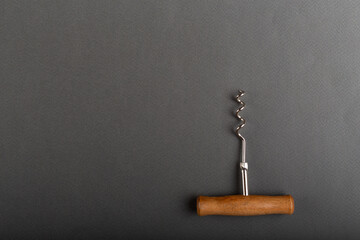 Corkscrew for wine bottle on gray background. Winemaking concept. Space for text.