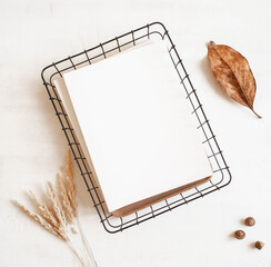 Empty blank white magazine or catalog cover mock up, autumn leaf and acorns and dried grass