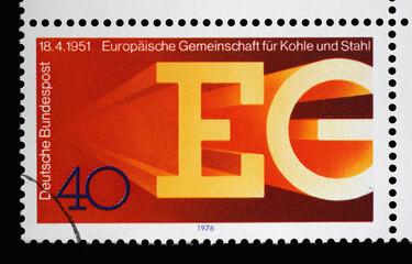 A stamp printed in Germany shows the European Union of Coal and Steel Letters EG formed from hot iron beams, circa 1976