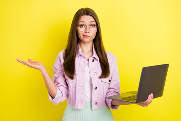 Portrait of attractive clueless girl copywriter using laptop studying learning web isolated over...