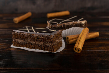 two chocolate-coated sponge cakes with cinnamon sticks