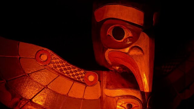 Totem Pole With Carved Bird In Firelight