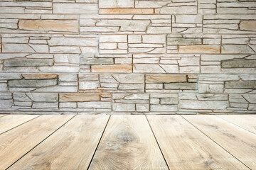 Empty wooden table on brick wall background