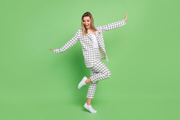 Fototapeta na wymiar Full length body size view of attractive cheerful elegant lady dancing having fun isolated over green color background