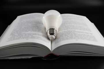 Led bulb in the middle of an open book