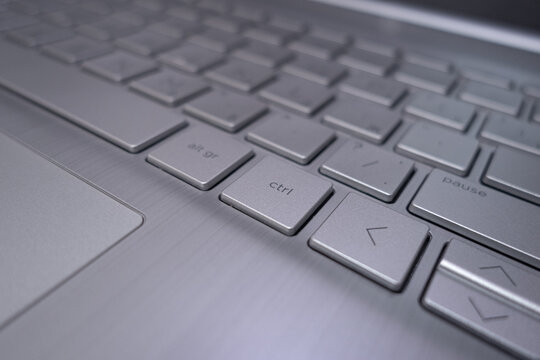 Close-up: laptop keyboard and touchpad. The aluminum surface.