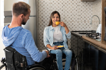 couple in wheelchair drinking coffee and enjoying afternoon.