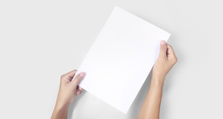 Hands holding paper blank for  letter paper
