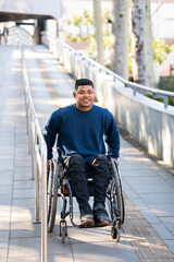 disabled person descending ramp of station.