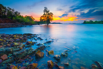 Fototapeta na wymiar Amazing sunset in Dangas beach, Batam island, stone on beach