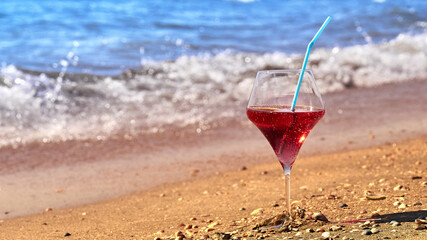 Wine glass with a cocktail by the sea.