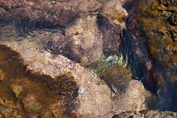 Tidal bore. Stone bottom. Clear water.