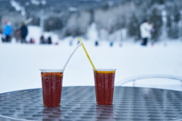 Image of plastic glasses with mulled wine on the table of the ski cafe.