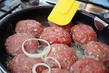 Cooking chops in a frying pan.