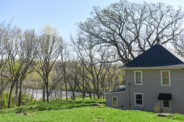 Gray farmhouse with oak trees