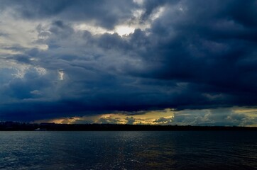 Naklejka na ściany i meble storm clouds over the lake