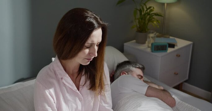 Angry unhappy couple ignoring not looking at each other after family fight, quarrel, upset thoughtful spouses avoiding talk, sitting silently at the bed, having relationship troubles. Quarrel concept