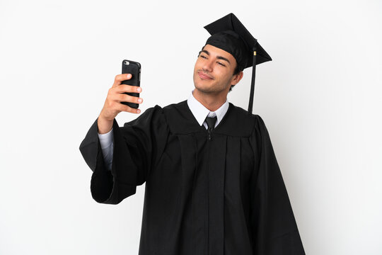 Young university graduate over isolated white background making a selfie