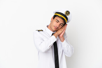 Airplane pilot over isolated white background making sleep gesture in dorable expression
