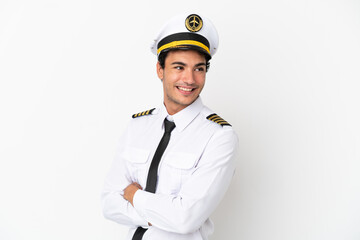 Airplane pilot over isolated white background with arms crossed and happy