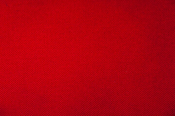 Texture of red cotton fabric closeup. Red textile background.