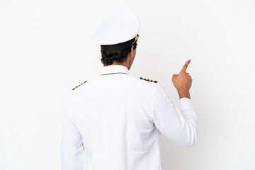 Airplane pilot over isolated white background pointing back with the index finger