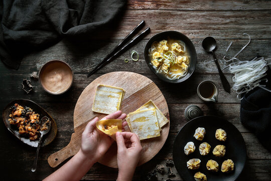 Woman making traditional wontons soup