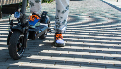 Electric Scooter, Electric Scooter Commuting.
Concept Object Photo Of Electric Scooter For Commuting. Close Up of Woman Commuting With Electric Scooter To Work.