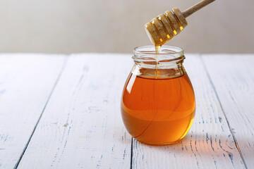 Honey background. Sweet honey in the comb, glass jar.