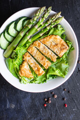 salad bowl chicken meat, asparagus, greens salad leaves vitamin eating organic diet on the table healthy food meal snack copy space food background rustic. top view keto or paleo diet veggie 
